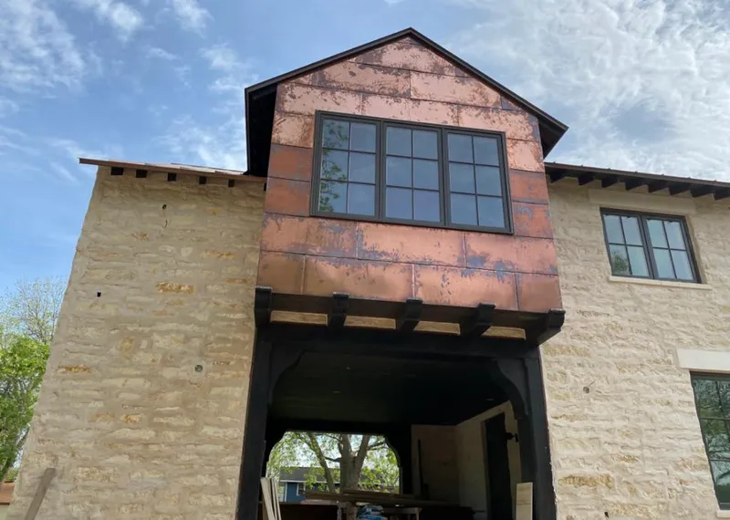 Copper metal panel facade on a stone building for Skylight Installation in La Vista